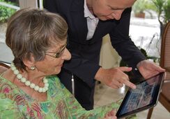 Older woman and younger man looking at a table screen.re